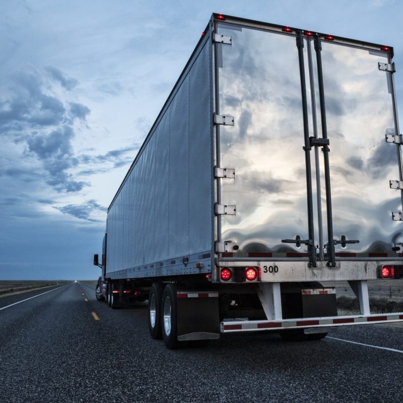 rear-view-of-the-trailer-on-a-class-8-commercial-truck-on-the-highway--e1607325652405.jpg